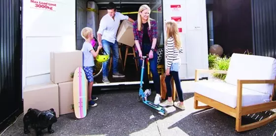 Family loading boxes into a goBox mobile storage container.
